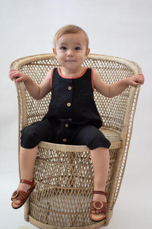 Toddler wearing black 100% hemp playsuit